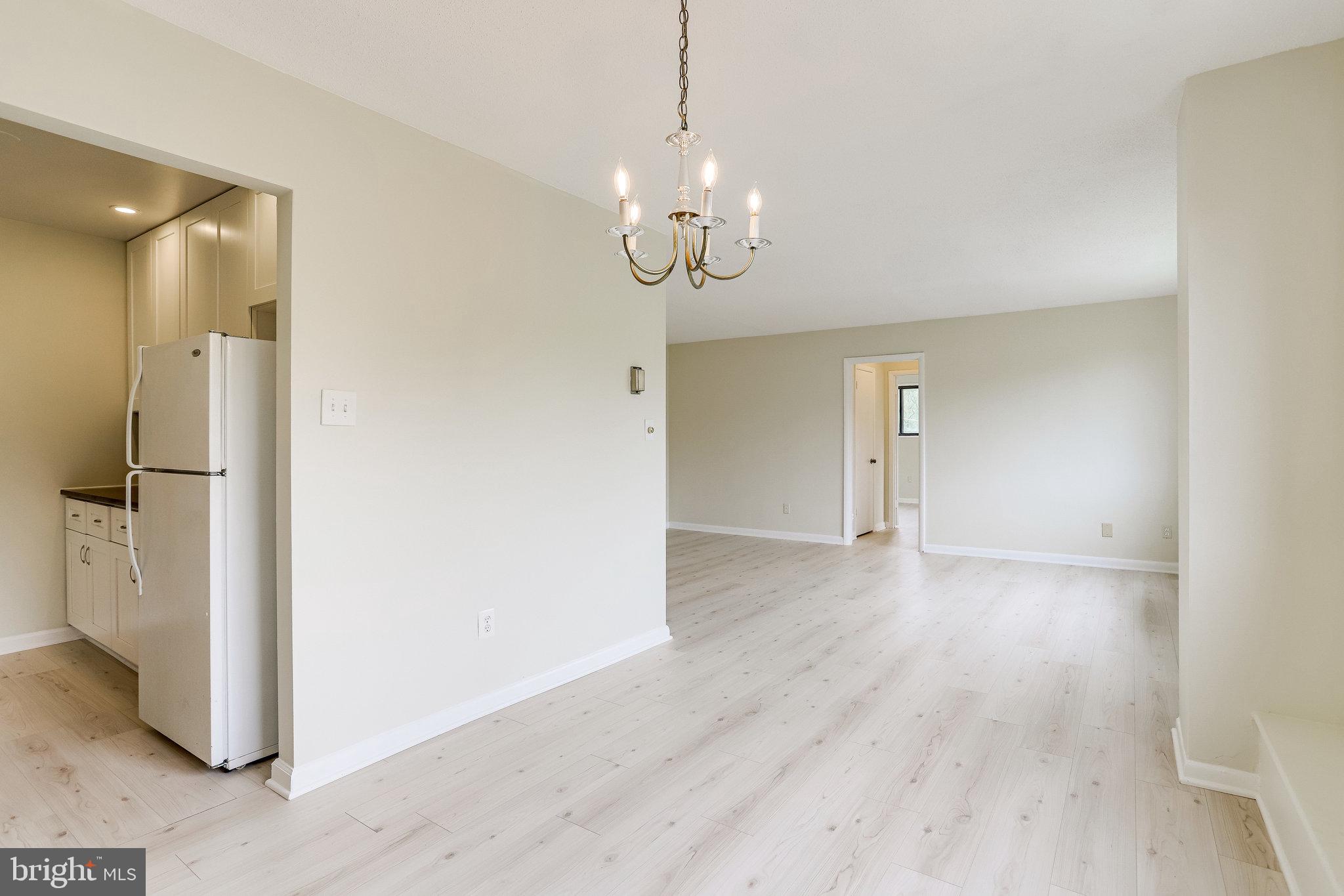 3515 Washington Boulevard, Unit 415 Arlington, VA 22201 - Photo 28 of 60 a view of a room with wooden floor and a ceiling fan
