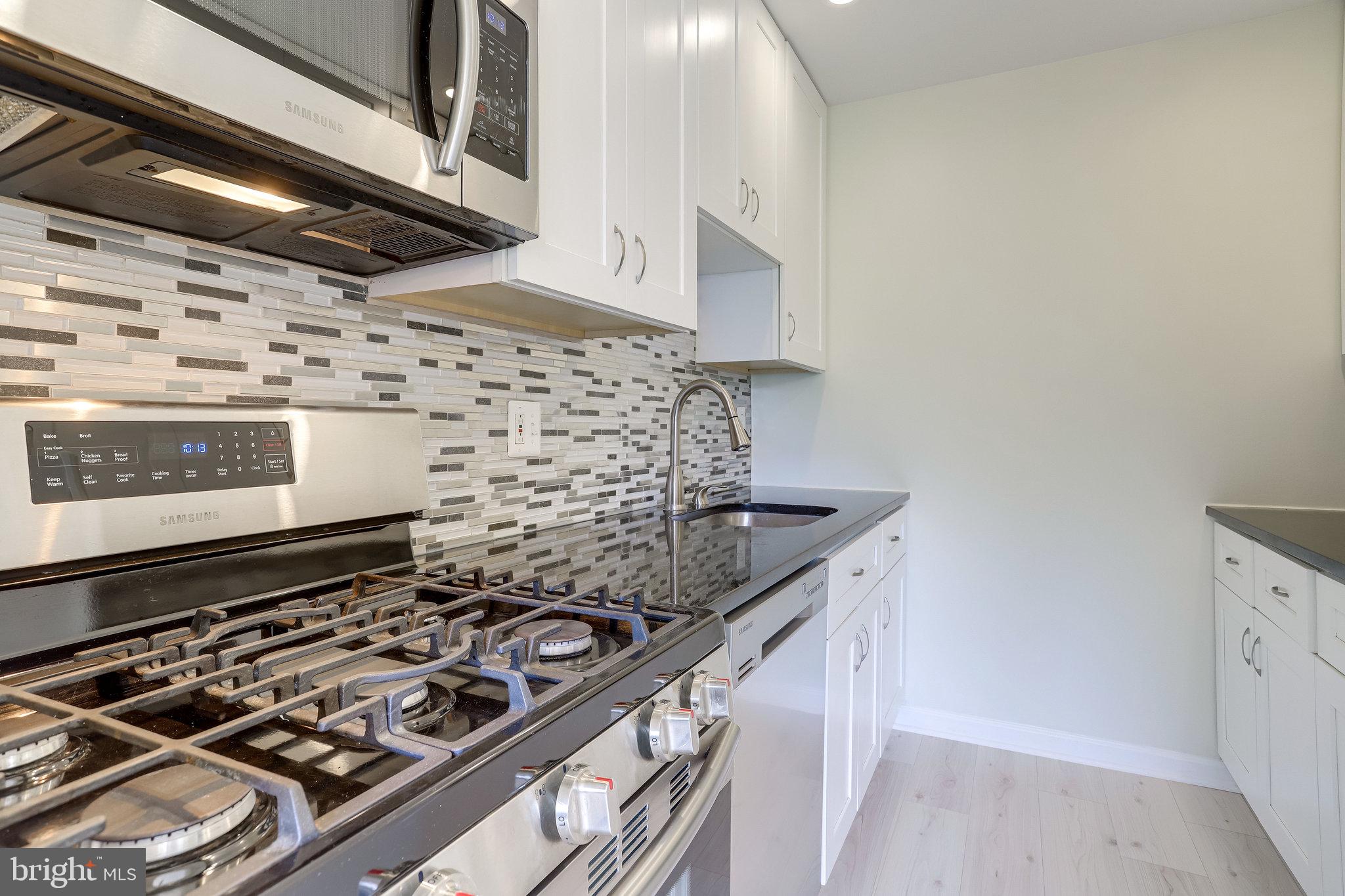 3515 Washington Boulevard, Unit 415 Arlington, VA 22201 - Photo 31 of 60 a stove top oven sitting inside of a kitchen