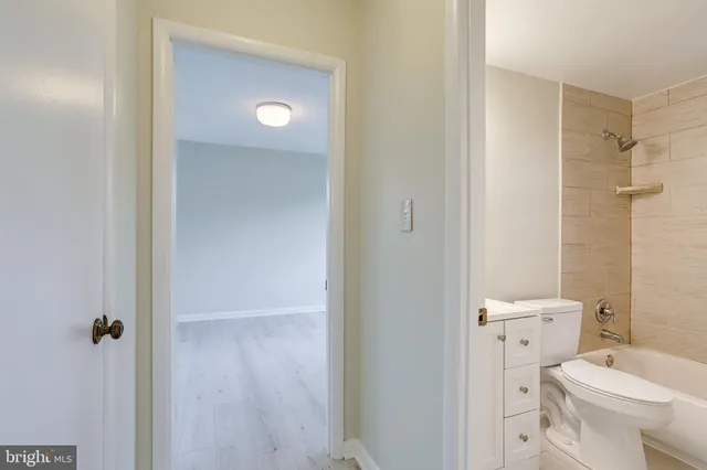 a bathroom with a toilet a sink and bathtub