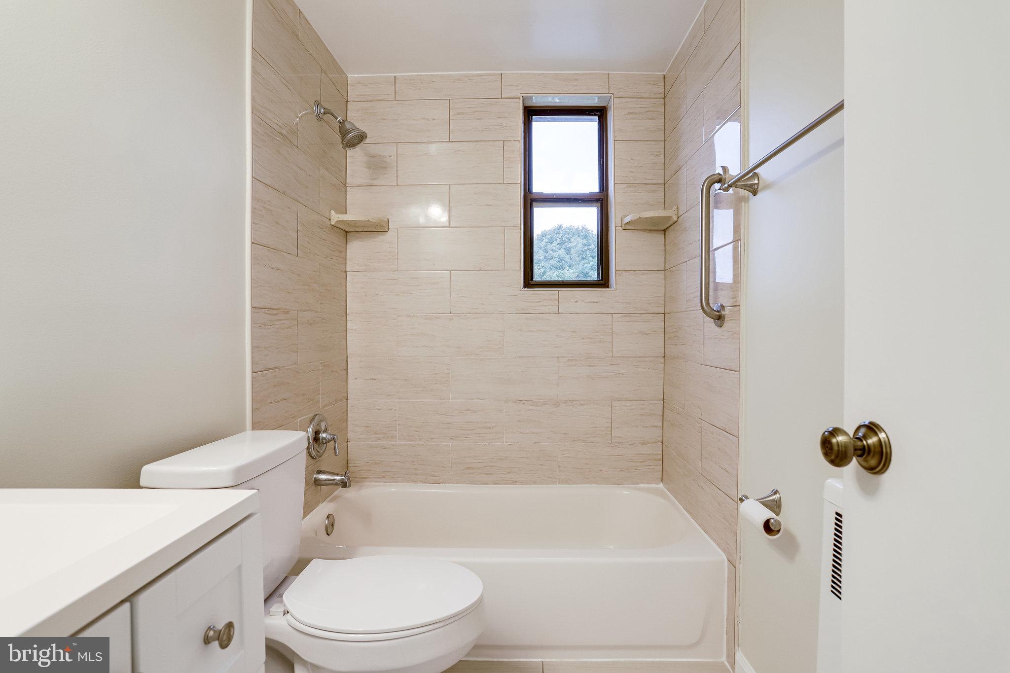 3515 Washington Boulevard, Unit 415 Arlington, VA 22201 - Photo 38 of 60 a bathroom with a toilet and a shower