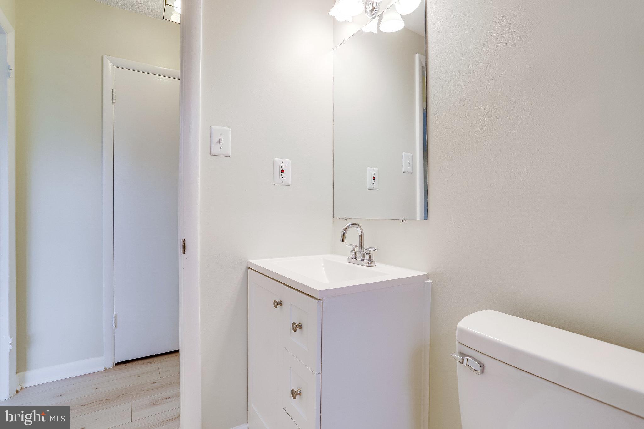 3515 Washington Boulevard, Unit 415 Arlington, VA 22201 - Photo 39 of 60 a bathroom with a toilet sink and mirror