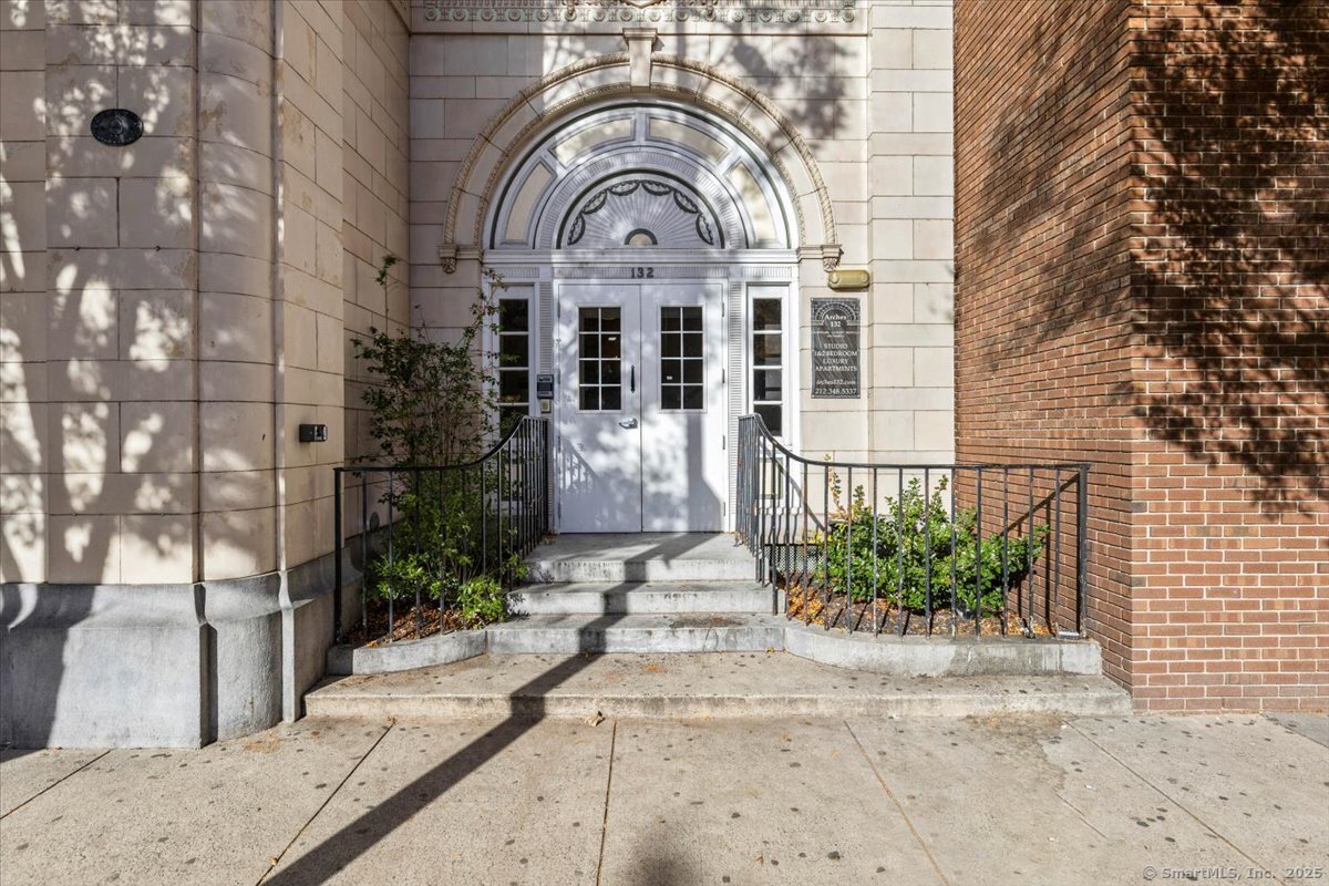 a view of a brick house with potted plants