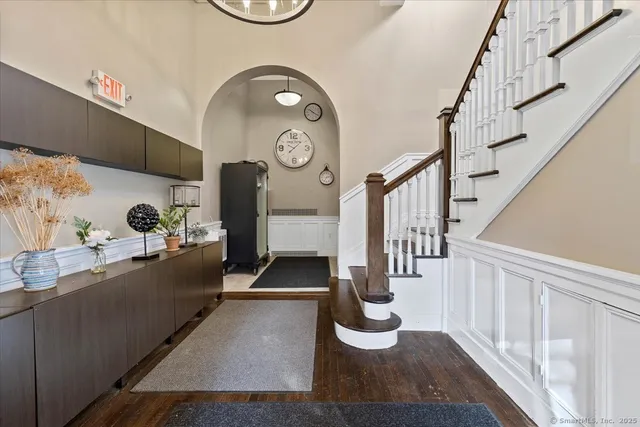 a view of entryway and hall with wooden floor
