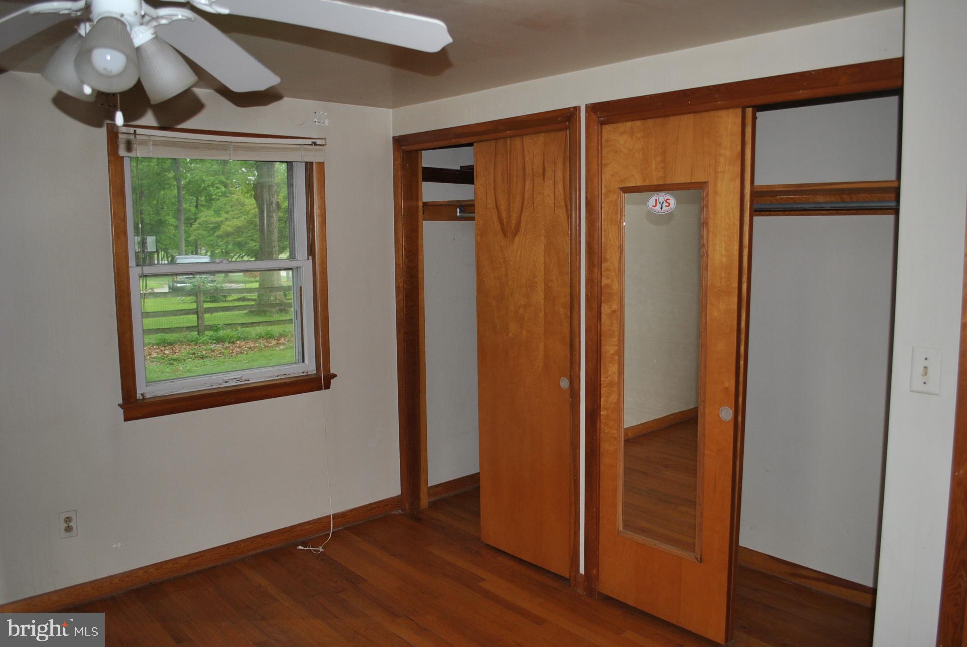 3803 Rockdale Road Manchester, MD 21102 - Photo 20 of 30 an empty room with wooden floor fan and windows