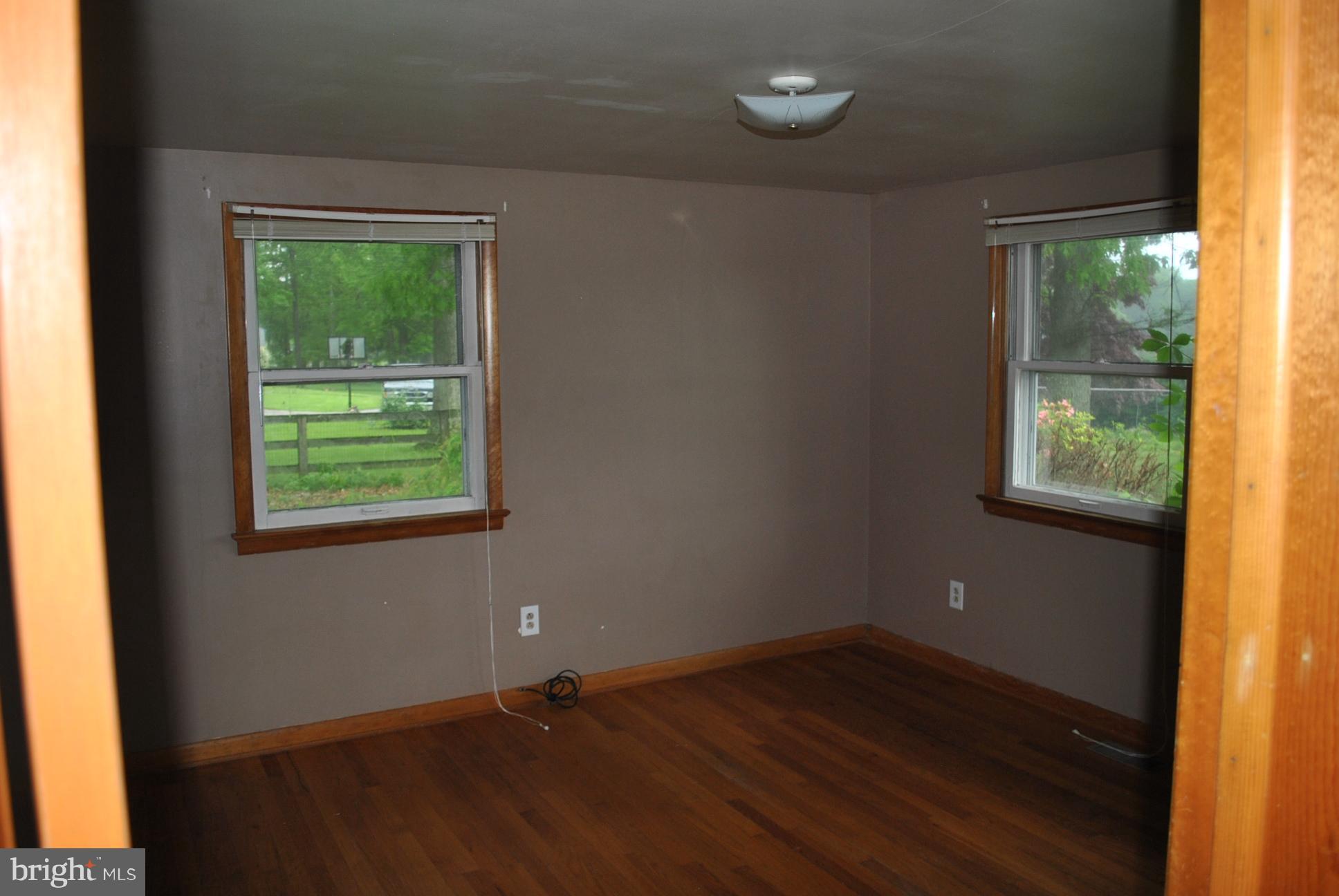 3803 Rockdale Road Manchester, MD 21102 - Photo 21 of 30 an empty room with wooden floor and windows