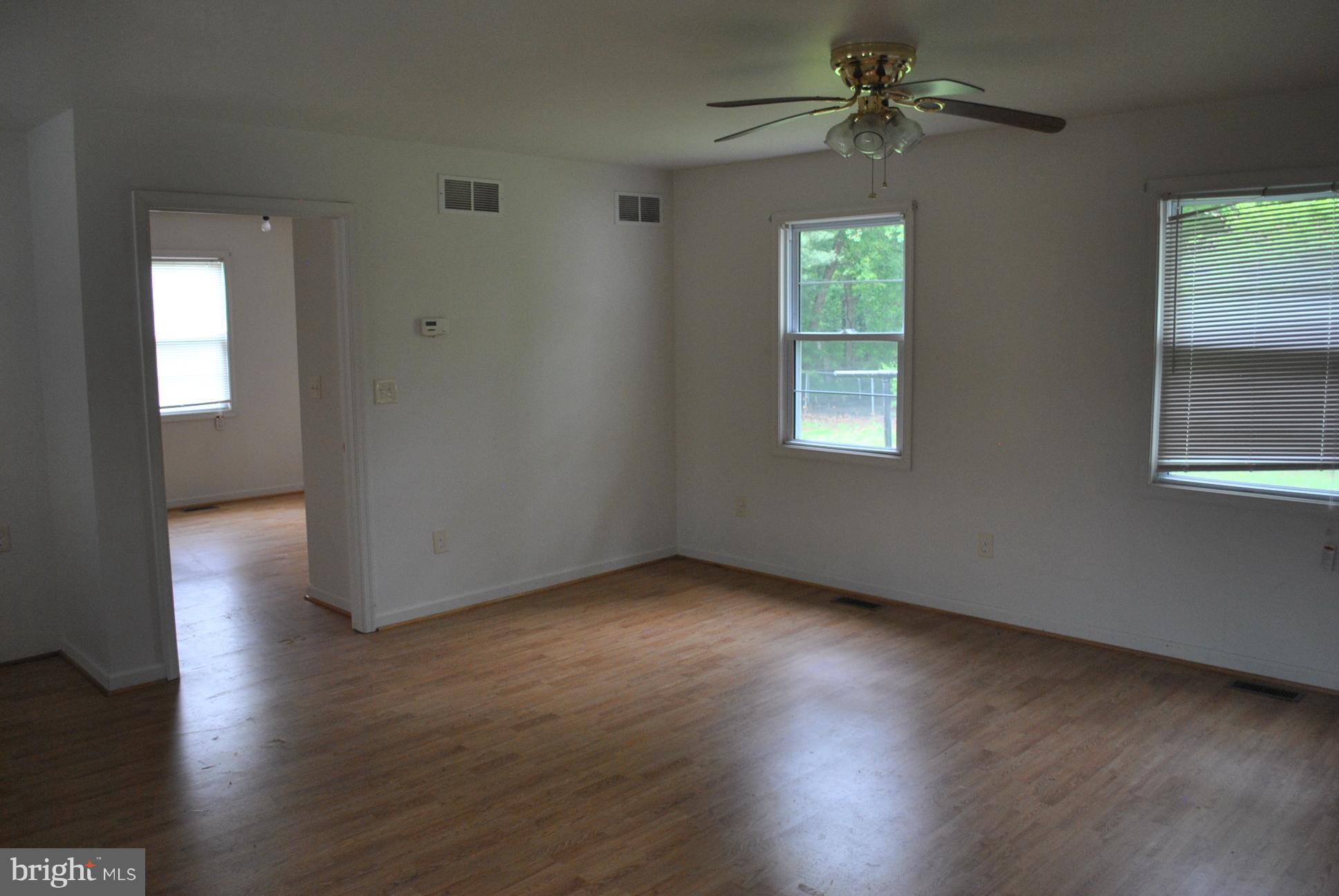 3803 Rockdale Road Manchester, MD 21102 - Photo 27 of 30 an empty room with wooden floor chandelier fan and windows