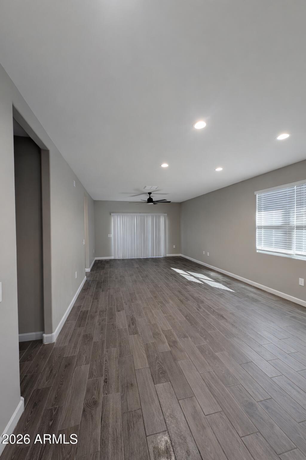 24208 West Ripple Road Buckeye, AZ 85326 - Photo 3 of 11 a view of empty room with wooden floor