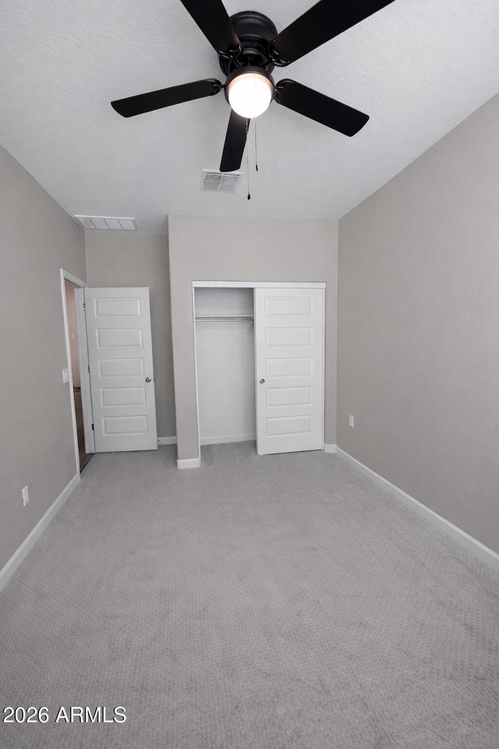 24208 West Ripple Road Buckeye, AZ 85326 - Photo 4 of 11 a view of an empty room with a ceiling fan
