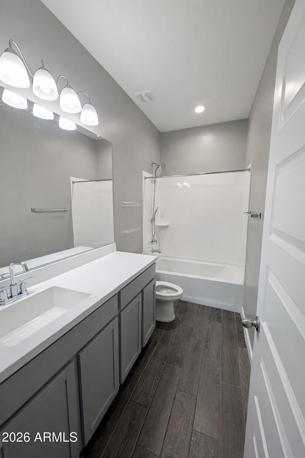 24208 West Ripple Road Buckeye, AZ 85326 - Photo 5 of 11 a bathroom with a double vanity sink a toilet and a mirror