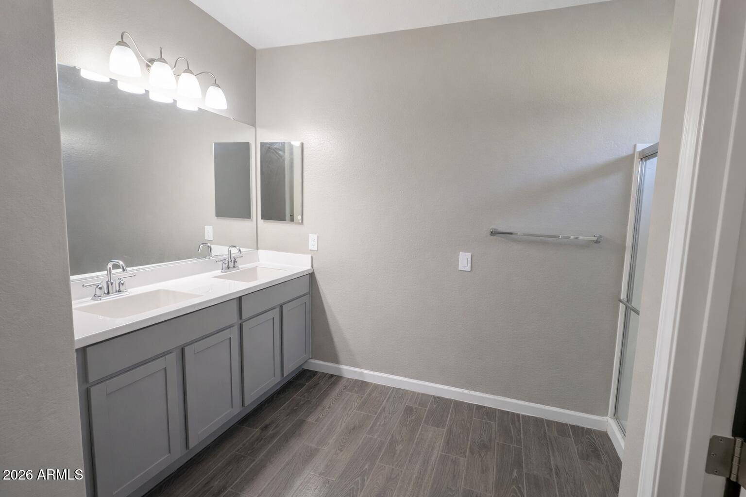 24208 West Ripple Road Buckeye, AZ 85326 - Photo 9 of 11 a bathroom with a double vanity sink and mirror