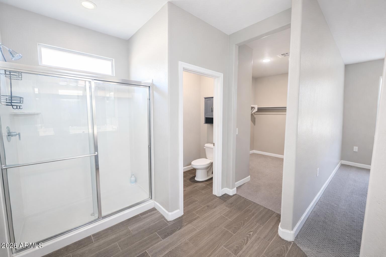 24208 West Ripple Road Buckeye, AZ 85326 - Photo 10 of 11 a view of bathroom with a shower and toilet