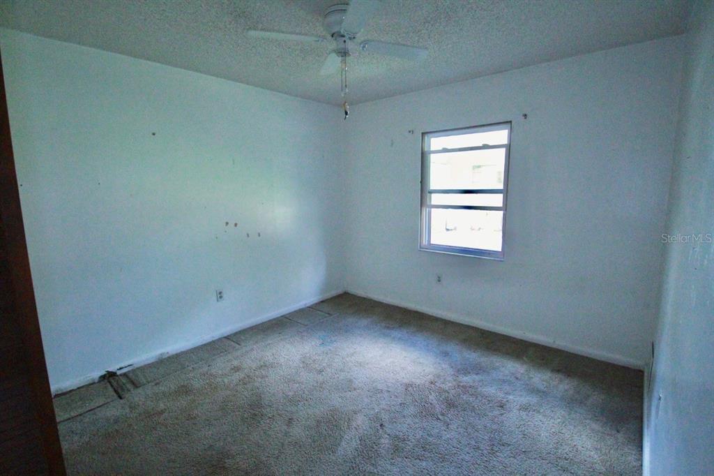 4090 Old Colony Road Mulberry, FL 33860 - Photo 11 of 22 an empty room with a window and ceiling fan