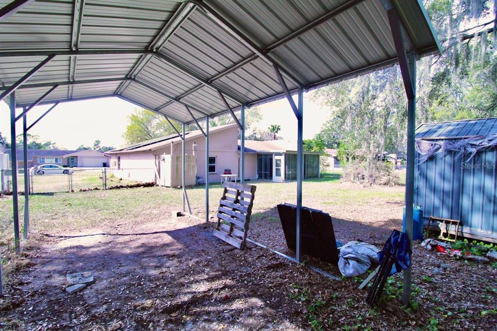 4090 Old Colony Road Mulberry, FL 33860 - Photo 18 of 22 a view of a backyard with table and chairs potted plants