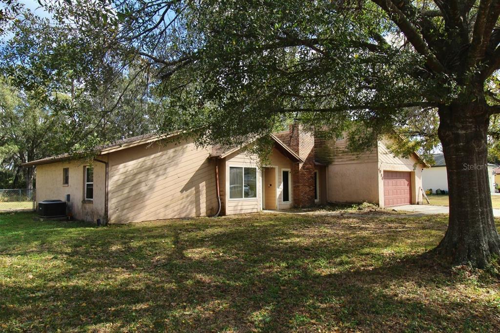 4090 Old Colony Road Mulberry, FL 33860 - Photo 20 of 22 a front view of house with yard and trees around