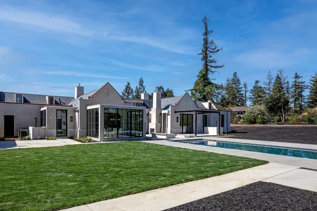 a front view of a house with a garden