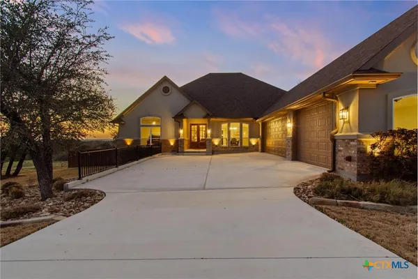 a large kitchen with stainless steel appliances a lot of counter space and wooden floor