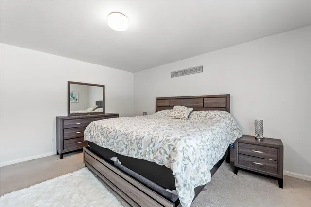 a bedroom with a bed and a lamp on table