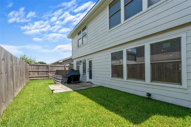 a view of a house with backyard porch and sitting area