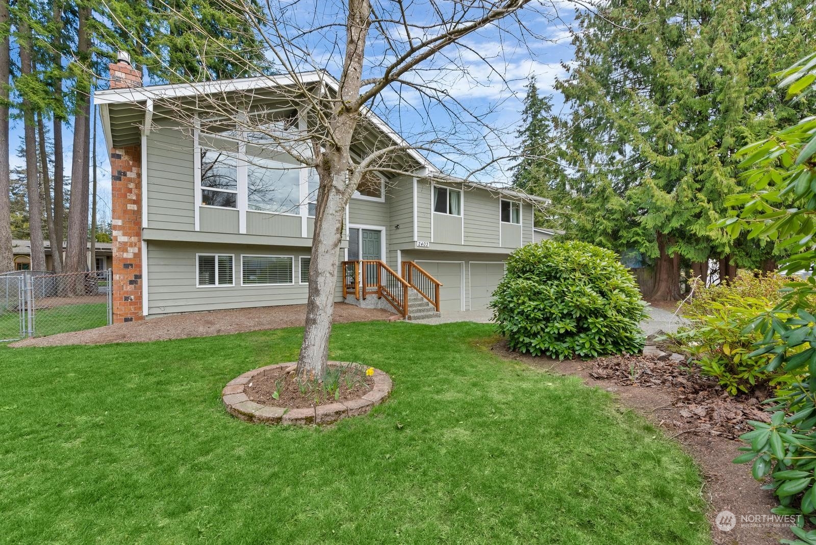 2403 166th Place Southeast Bothell, WA 98012 - Photo 5 of 29 a house view with a garden space