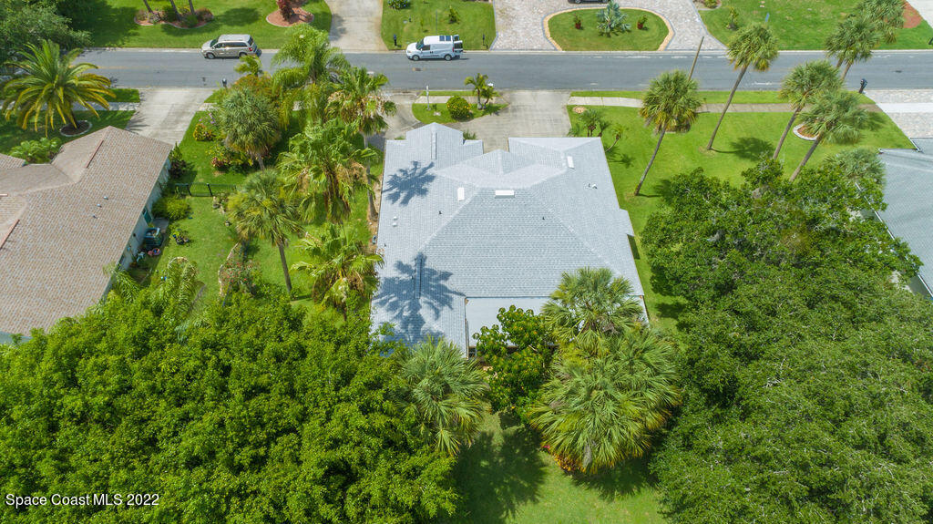 1190 Meadowbrook Road Northeast Palm Bay, FL 32905 - Photo 3 of 27 an aerial view of a house with a yard and greenery