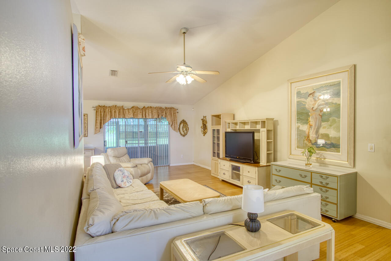 1190 Meadowbrook Road Northeast Palm Bay, FL 32905 - Photo 8 of 27 a living room with furniture and a flat screen tv