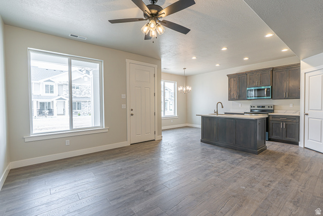 2249 South 1090 West, Unit 76 Nibley, UT 84321 - Photo 2 of 19 Open-concept living space featuring wood-finish flooring, a contemporary ceiling fan, and recessed lighting