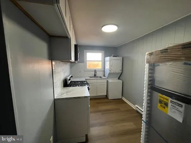 a kitchen with a refrigerator sink and stove