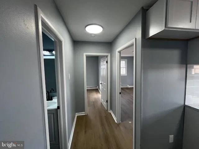 a view of a hallway with wooden shelves