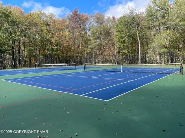 a view of an outdoor space and tennis court