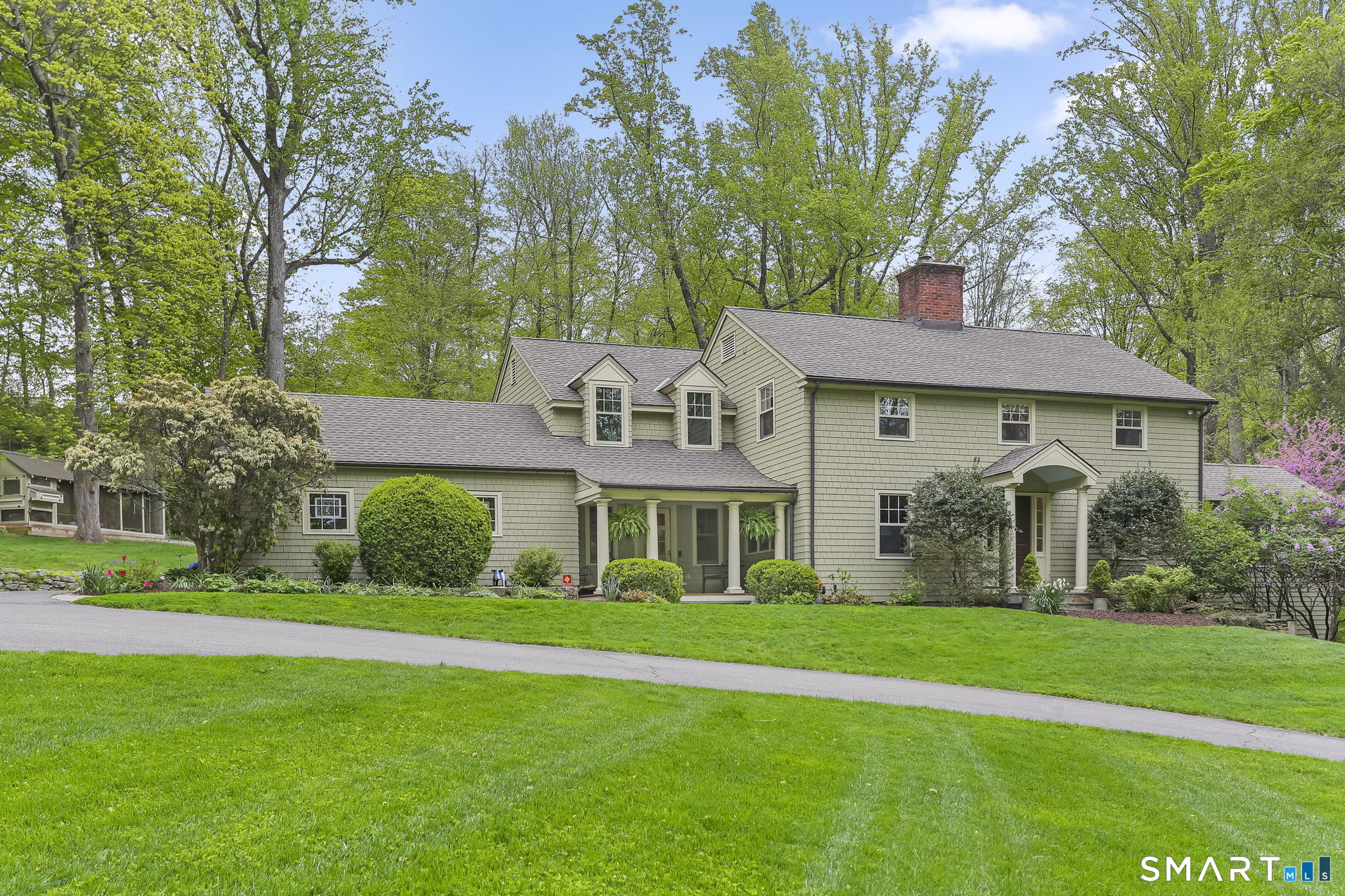 23 Old Stage Coach Road Weston, CT 06883 - Photo 3 of 37 a front view of a house with a garden