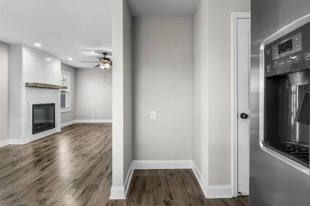 an empty room with a ceiling fan and carpet