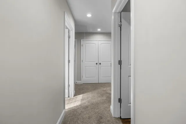 a bathroom with a double vanity sink a toilet and a mirror