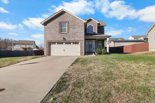 a view of a big house with a big yard and large trees