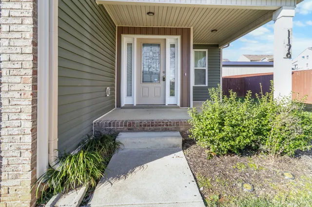 a view of an empty room with a fireplace and a window