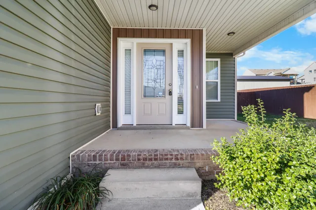 a kitchen with stainless steel appliances kitchen island granite countertop a sink refrigerator and cabinets