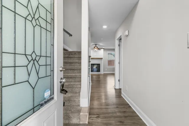 a kitchen with stainless steel appliances granite countertop a sink a stove a refrigerator and island with wooden floor