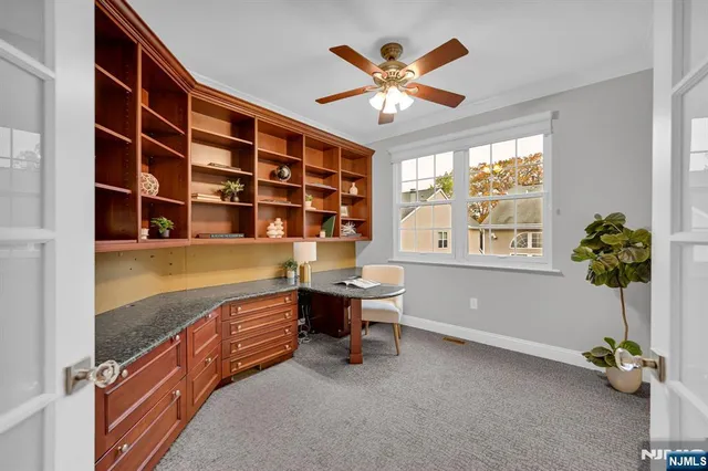 a view of a livingroom with workspace and a window