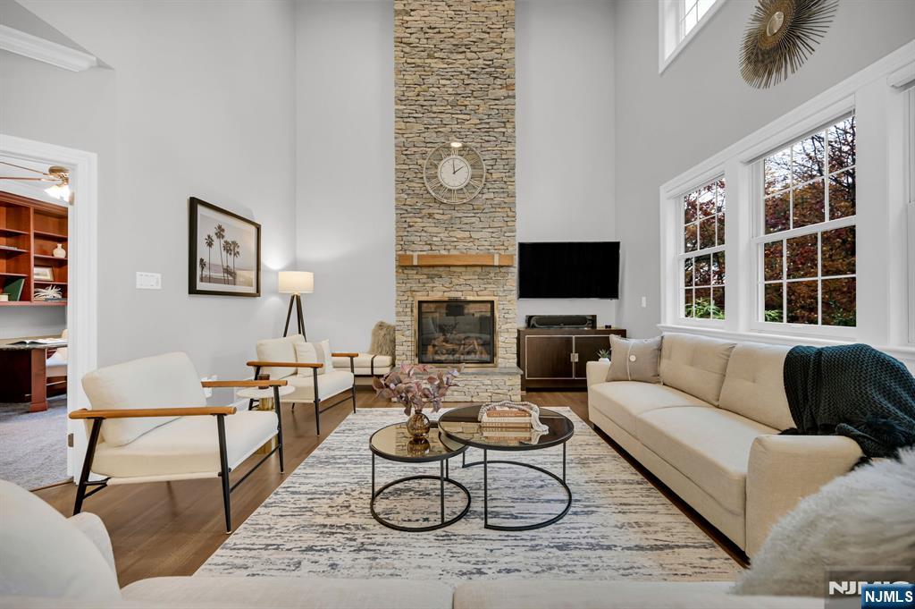 3 Brook Ridge Court Cedar Grove, NJ 07009 - Photo 13 of 49 a living room with furniture a flat screen tv and a large window