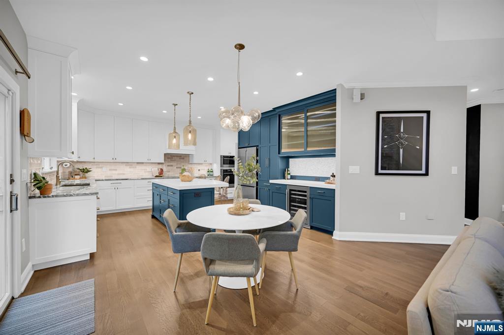 3 Brook Ridge Court Cedar Grove, NJ 07009 - Photo 15 of 49 a kitchen with a dining table chairs and refrigerator