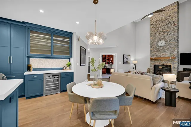 a kitchen with a dining table chairs and sink