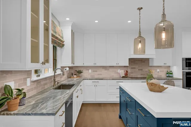 a kitchen with a sink a stove a microwave and cabinets