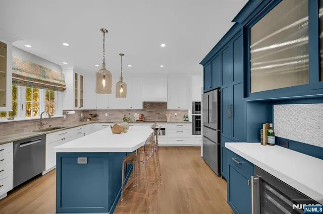 a kitchen with a sink a counter top stainless steel appliances and cabinets