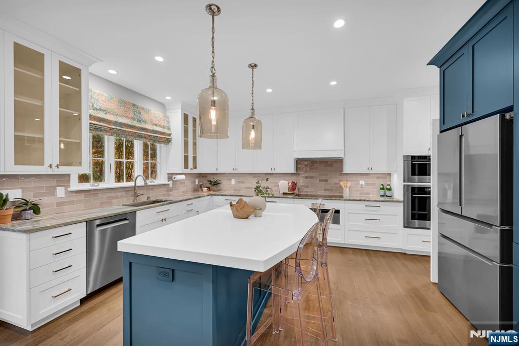 3 Brook Ridge Court Cedar Grove, NJ 07009 - Photo 20 of 49 a kitchen with a refrigerator a sink and a stove top oven