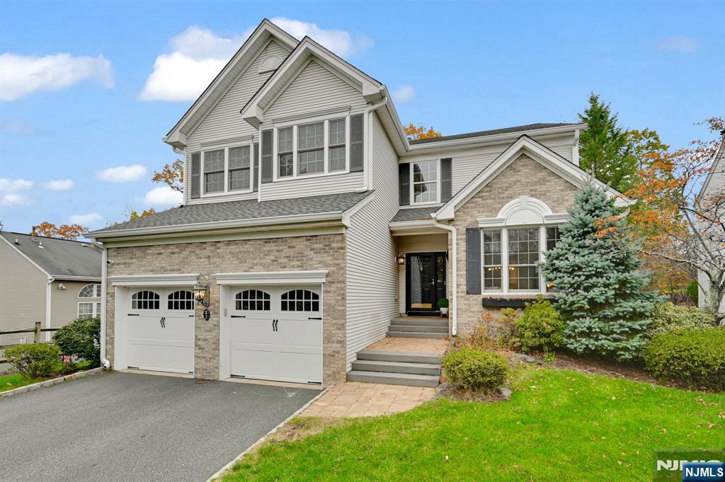 3 Brook Ridge Court Cedar Grove, NJ 07009 - Photo 2 of 49 a front view of a house with a yard