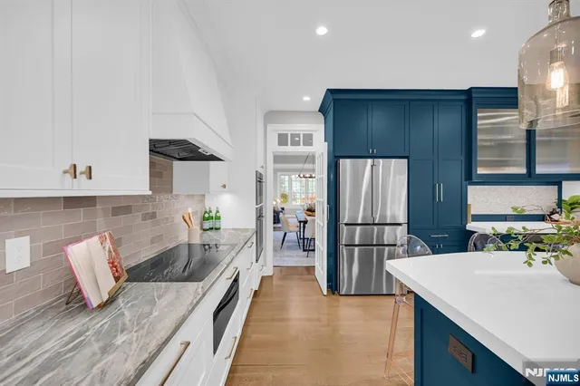a kitchen with refrigerator and cabinets