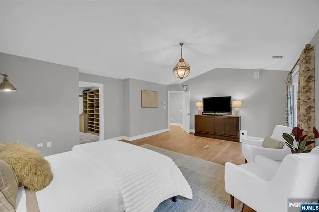 a bedroom with a bed and a television