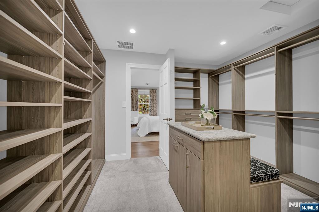 3 Brook Ridge Court Cedar Grove, NJ 07009 - Photo 26 of 49 a bathroom with a granite countertop sink a toilet and a mirror