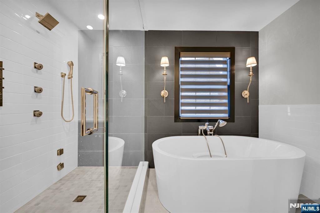 3 Brook Ridge Court Cedar Grove, NJ 07009 - Photo 28 of 49 a bathroom with a bathtub and a shower