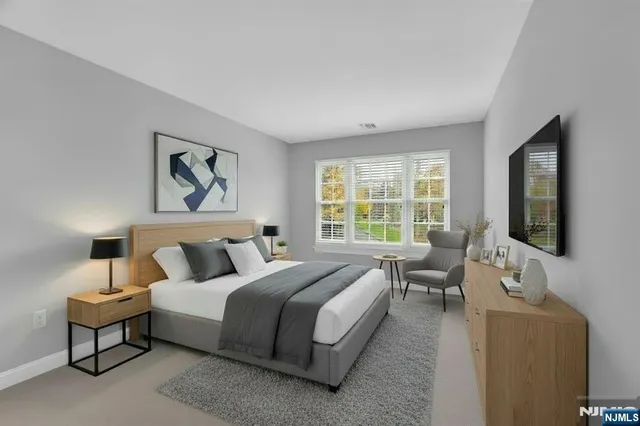 a bedroom with bed couch and window