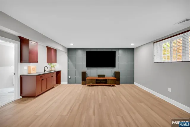 a living room with a flat screen tv and a table